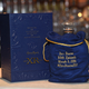 A bottle of Crown Royal with one of its custom embroidered bags